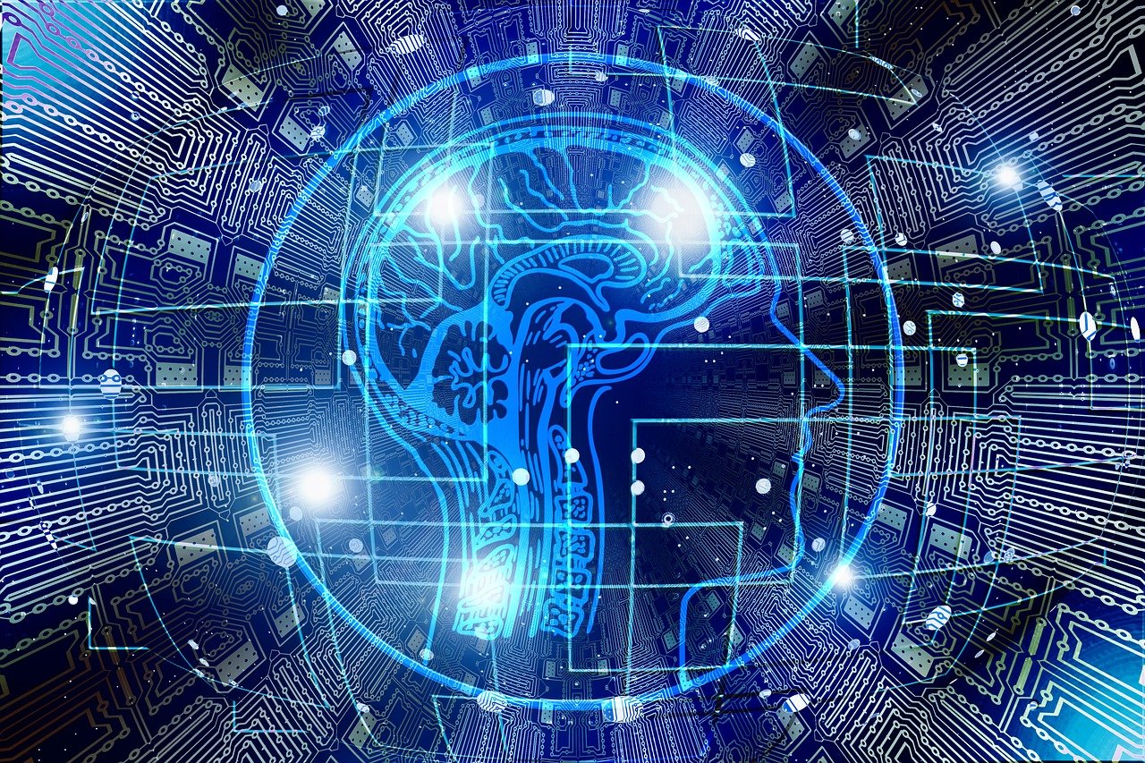 “Digital illustration of a human head outlined in blue with a glowing brain, overlaid on a circuit-board background symbolizing artificial intelligence and human–machine integration.”